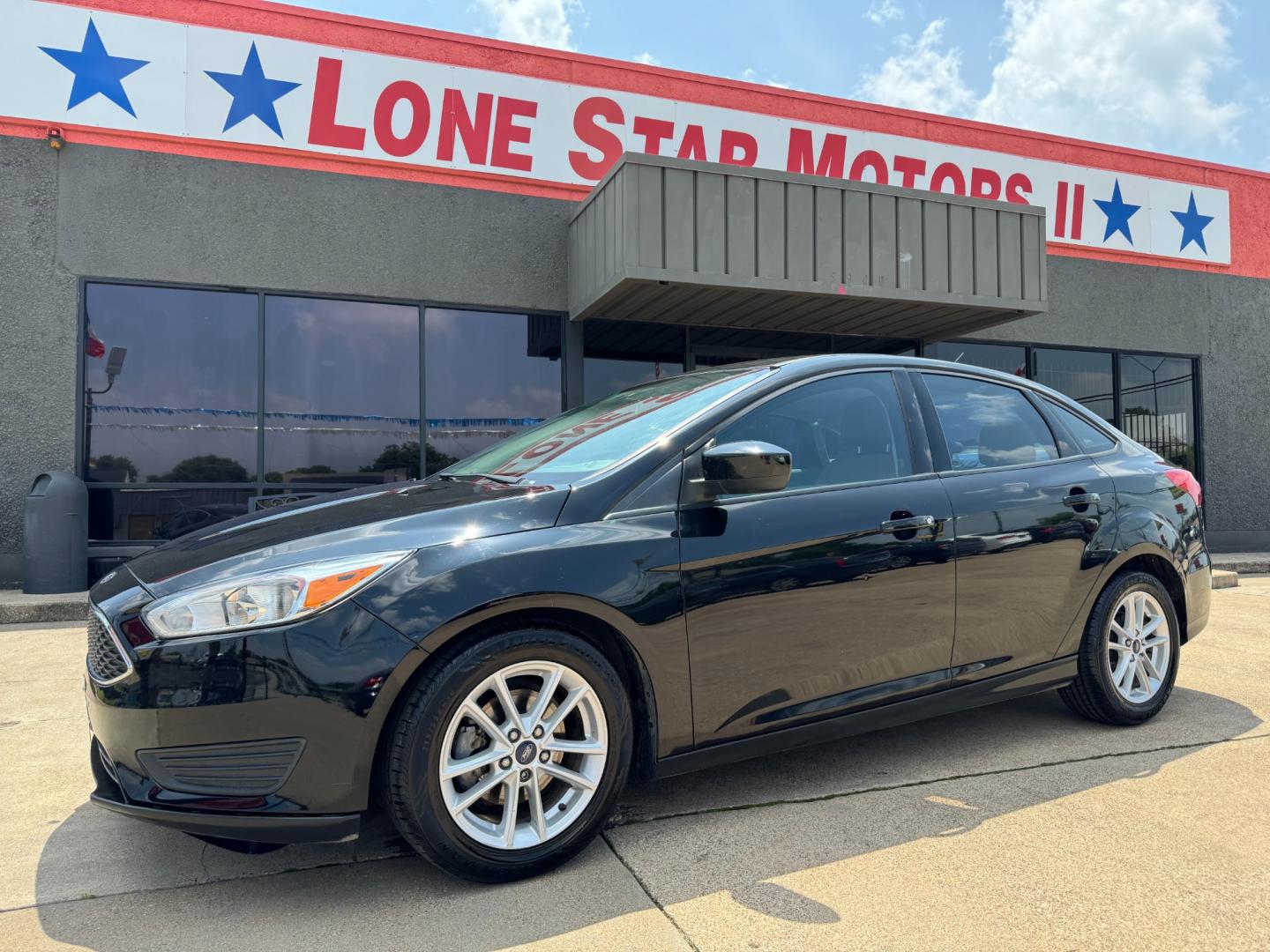 2018 BLACK /Gray FORD FOCUS SE 4dr Sedan (1FADP3F26JL) with an 2.0L I4 engine, Automatic 6-Speed transmission, located at 5900 E. Lancaster Ave., Fort Worth, TX, 76112, (817) 457-5456, 0.000000, 0.000000 - This is a 2018 Ford Focus SE 4dr Sedan that is in excellent condition. There are no dents or scratches. The interior is clean with no rips or tears or stains. All power windows, door locks and seats. Ice cold AC for those hot Texas summer days. It is equipped with a CD player, AM/FM radio, AUX port, - Photo#0